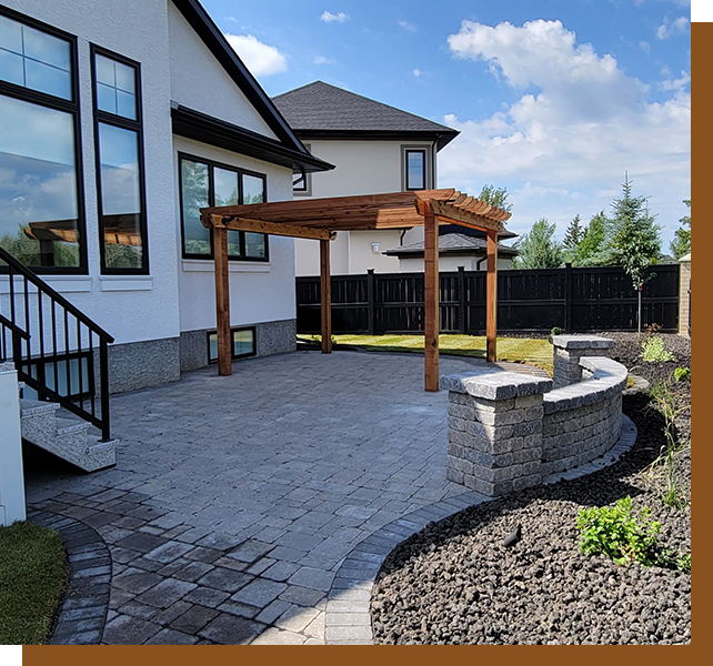 A patio with a pergola and stone wall