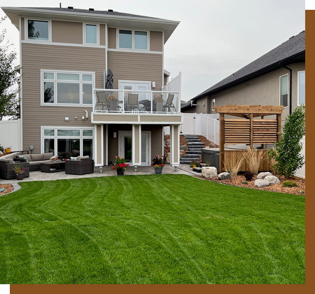 A large backyard with a lawn and a deck.